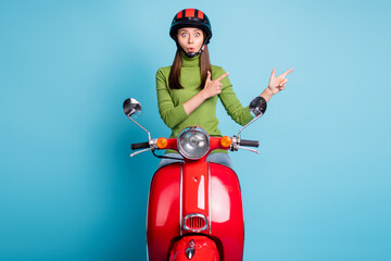 Photo of impressed attractive lady open mouth direct fingers empty space isolated on blue color...