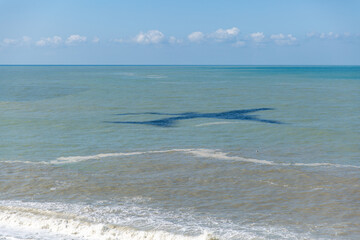 aircraft shadow over the sea