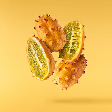 Fresh ripe kiwano falling in the air isolated