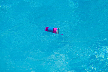 Drown drowned human in pool. Cocktail bottle floating in swimming water.