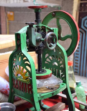 Machine used for crushing ice for preparing the famous Indian Chuski or ice pop 
