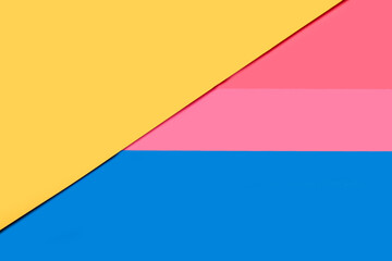  Fondo geométrico de papel amarillo, rosa y azul. Vista superior. Copy space