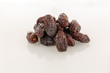 a handful of large dates fruit on a white background
