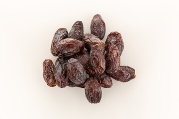 a handful of large dates fruit on a white background