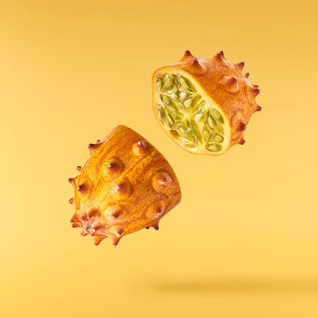 Fresh ripe kiwano falling in the air isolated