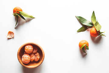 beautiful ripe tangerines with green leaves on wooden plate