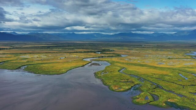 Aerial view of Avacha river delta and hilly landscape, Kamchatka Peninsula, Russia, 4k