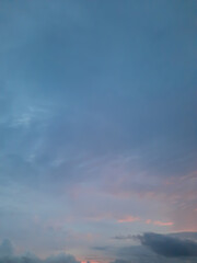 Pastel turquoise cloudscape background with smooth cloud shapes and sunlight.