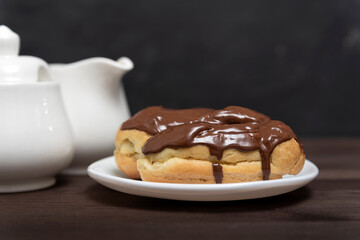 Traditional french eclairs with chocolate topping. Pastries for tea. Close up