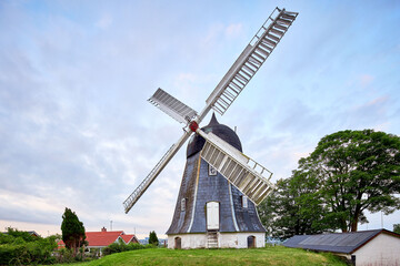 Fototapeta na wymiar antique windmill next to house in denmark