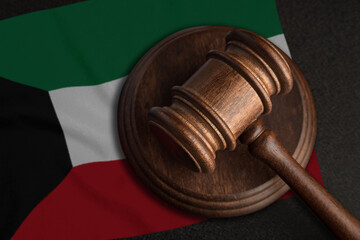 Judge gavel and flag of Kuwait. Law and justice in Kuwait. Violation of rights and freedoms