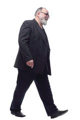 satisfied man in a business suit striding forward .