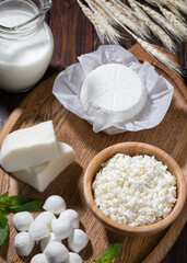 Homemade cottage cheese with milk on wooden table..