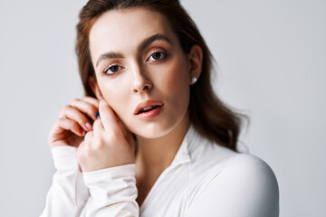 Close up portrait of sensual pretty young woman in white clothes