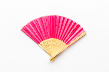 Top view of pink hand fan made of bamboo and paper