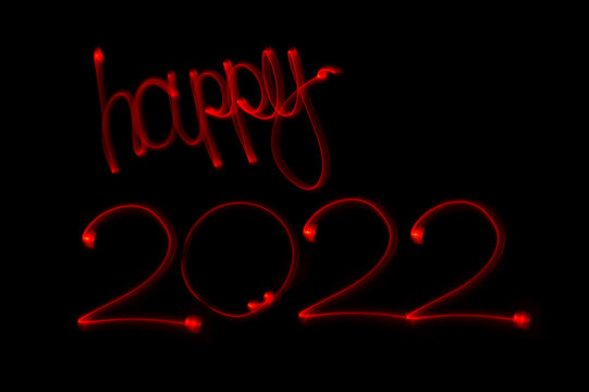 happy 2022, geschrieben mit Licht. Ein schöner grafischer Hintergrund für Ihr Grafikprojekt