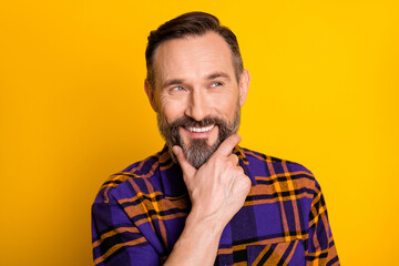 Fototapeta premium Portrait of attractive cheerful curious guy wearing checked shirt making decision isolated over bright yellow color background