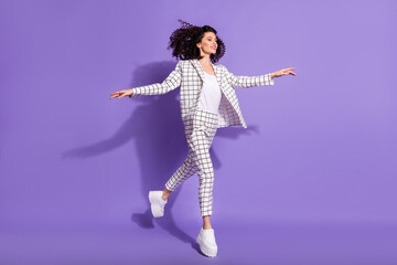 Full length photo portrait of elegant woman walking running jumping up isolated on vivid purple...