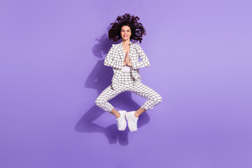 Full size photo of young excited girl happy positive smile jump wait expect wish isolated over purple color background