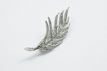 Original silver brooch on white background accessory
