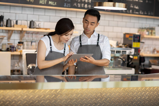 Young couple working in coffee shop