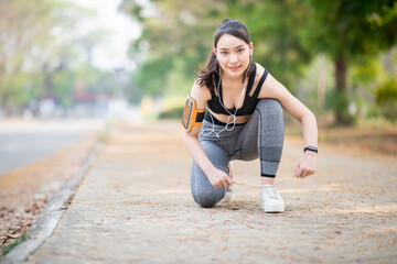 Naklejka na ściany i meble Women's Health Concept,Asian young woman exercise and running ,making fitness workout at park 