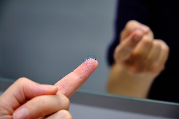 Obraz premium A woman's hands with a contact lens. Vision Correction and Health Care. Contact Lenses.