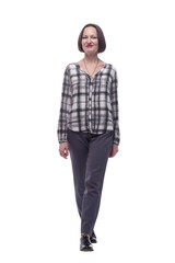 attractive mature woman in a checked shirt striding forward.
