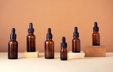 Glass bottles on wooden podiums for serum on beige background