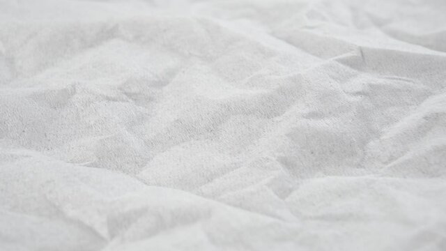 Wrinkled paper white facial tissue. Crumpled texture close-up. Dolly shot. Macro. Abstract surface