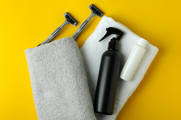 Concept of men's hygiene tools on yellow background