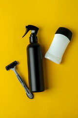 Concept of men's hygiene tools on yellow background