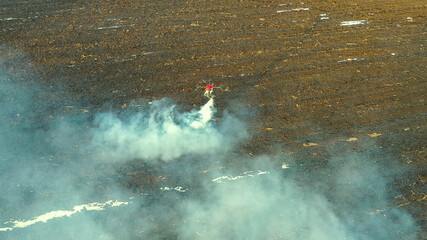 The agrodron flies over the field and sprays fertilizers.