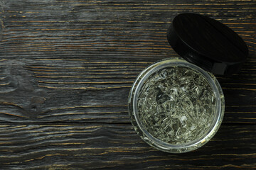 Jar of styling gel on wooden table