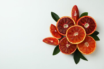 Red orange slices with leaves on white background, space for text