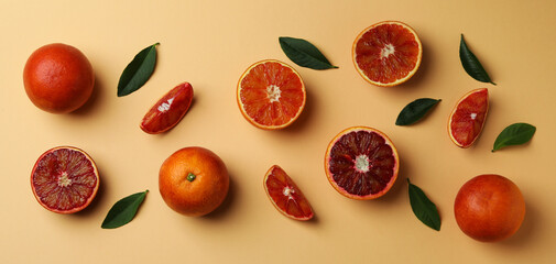 Red oranges and leaves on beige background