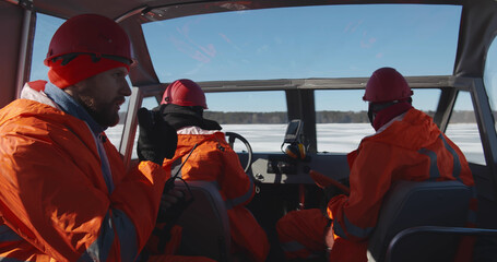 Professional lifesaving team sailing air-boat in arctic