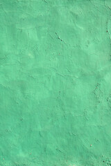 Old wall texture with cracked paint of green color