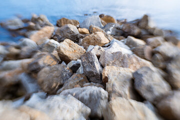 Rocks and stones on a the shore of a blue sea or lake