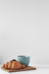 Mug and croissants on a white background. Eco-friendly and natural materials in the decor, dessert. Copy space, mock up.