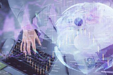 Multi exposure of man's hands typing over computer keyboard and forex graph hologram drawing. Top view. Financial markets concept.