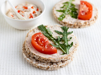 Closeup of crispbread with tomato slice on the table.