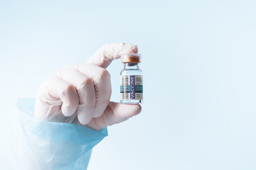 NO LOGOS OR TRADEMARKS!  SELF MADE LABELS! Close up view of doctor’s hand with an ampule of covid...