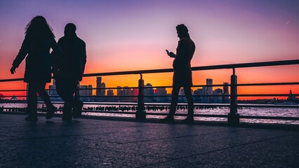 Fototapeta na wymiar silhouette of a people walking at sunset