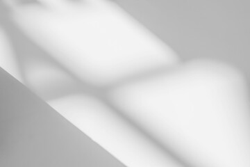 Abstract light reflection and grey shadow from window on white wall background , dark gray and sunshine diagonal geometric effect overlay