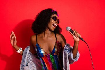 Photo of funky charming curly dark skin woman dressed pinup clothes spectacles singing karaoke...