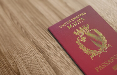 Malta passport, carried by a Maltese citizen, on a wooden floor