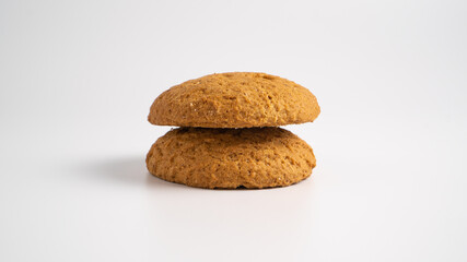Fototapeta na wymiar Empty oatmeal cookies on white background. Two traditional oatcakes. Stack of simple oat cookies