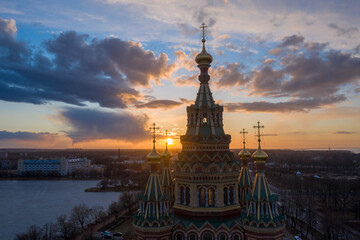 Aerial view of the Cathedral of Saints Peter and Paul, golden domes in the beautiful setting sun. Orthodox church in Peterhof. Facade of the church close-up.