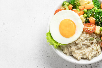 Savory oats veggie egg bowl. Space for text, top view.